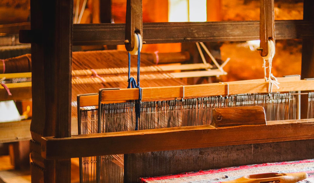 A traditional manually operated machine used in a textile factory in Nepal.